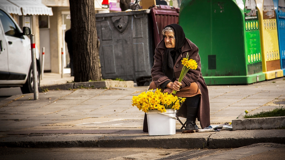 bigstock-poor-homeless-old-woman-sells-278384254-990x556